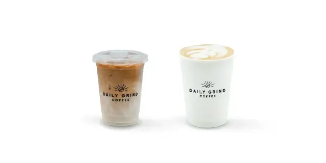 Daily Grind iced caramel macchiato with espresso layered over milk, beside a hot latte with latte art