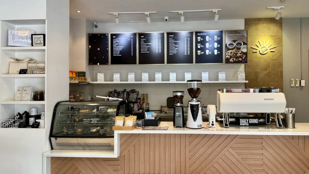 Daily Grind Coffee bar with espresso machine, menu boards and pastry case