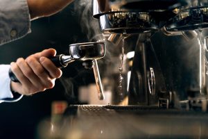 barista brewing- coffee using espresso machine