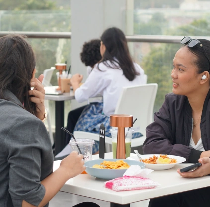 book us an event two women eating and watching at alfresco