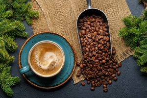 Coffee cup and fir tree branches in cozy setting